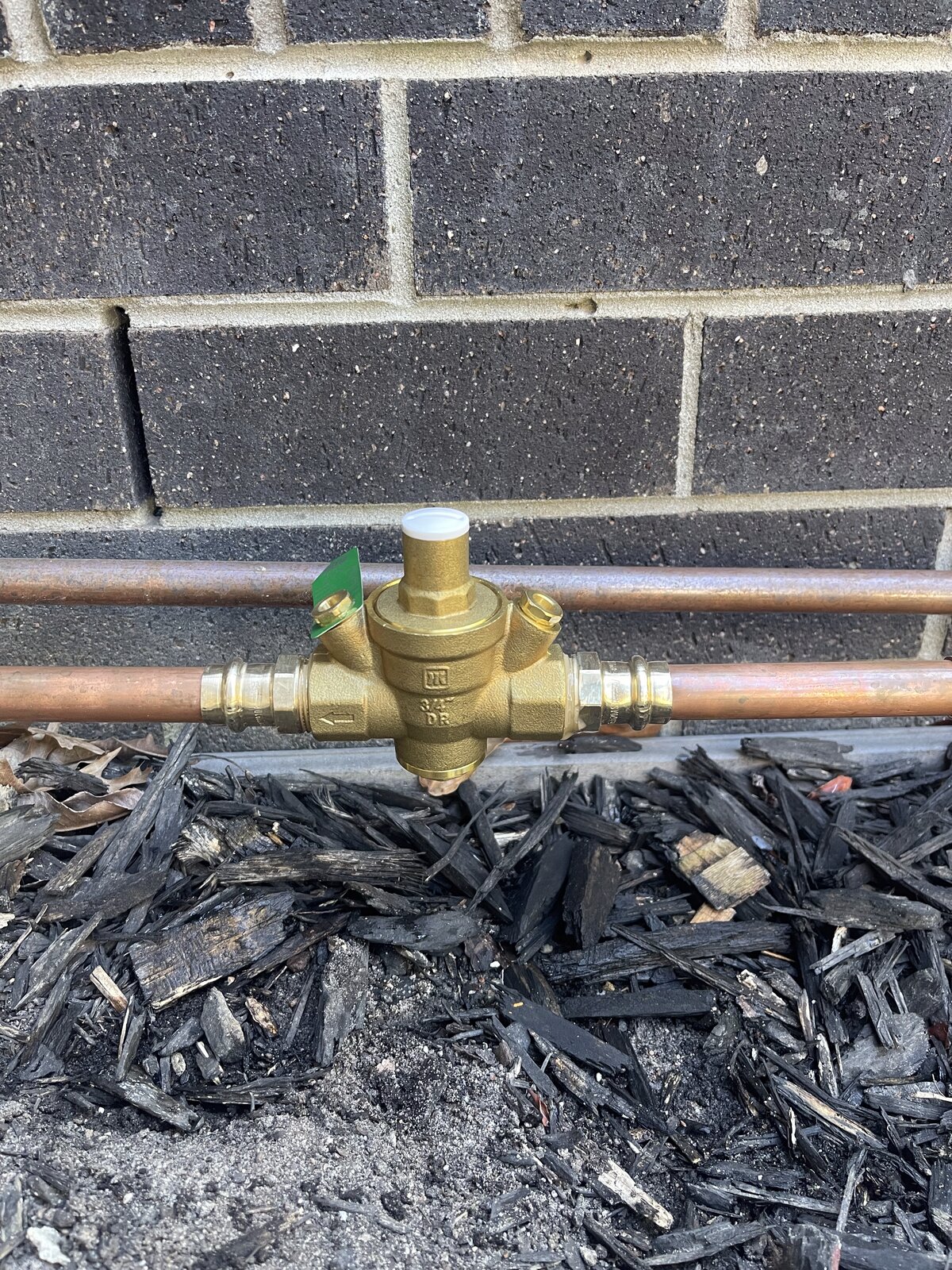 Brass pressure reducing valve on copper supply line in garden Brighton Melbourne